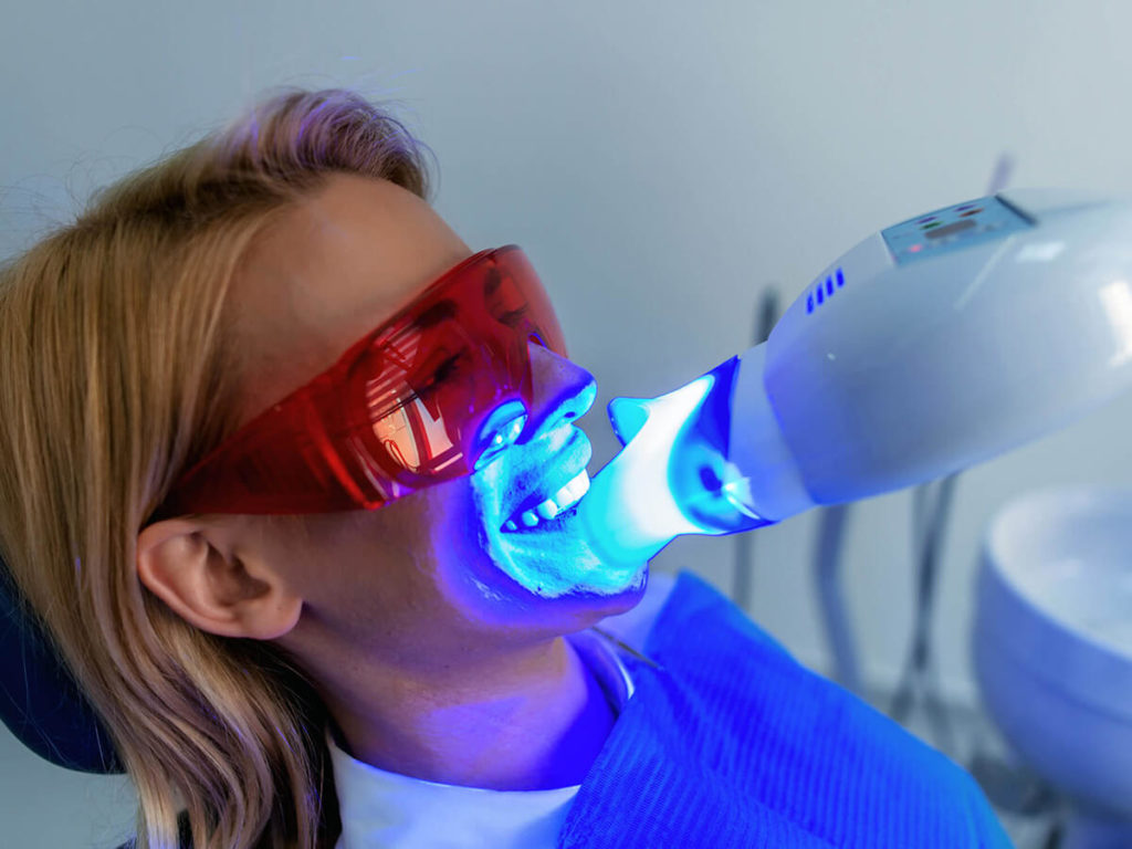 A woman receiving teeth whitening