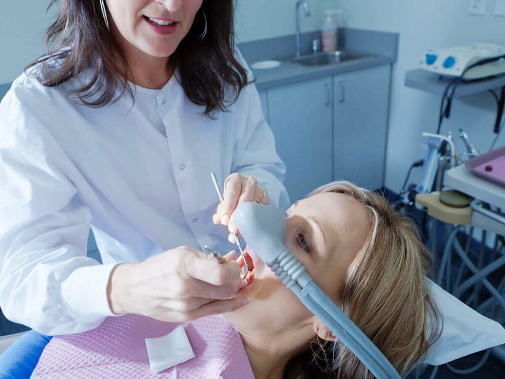 dentist working on a patient receiving sedation